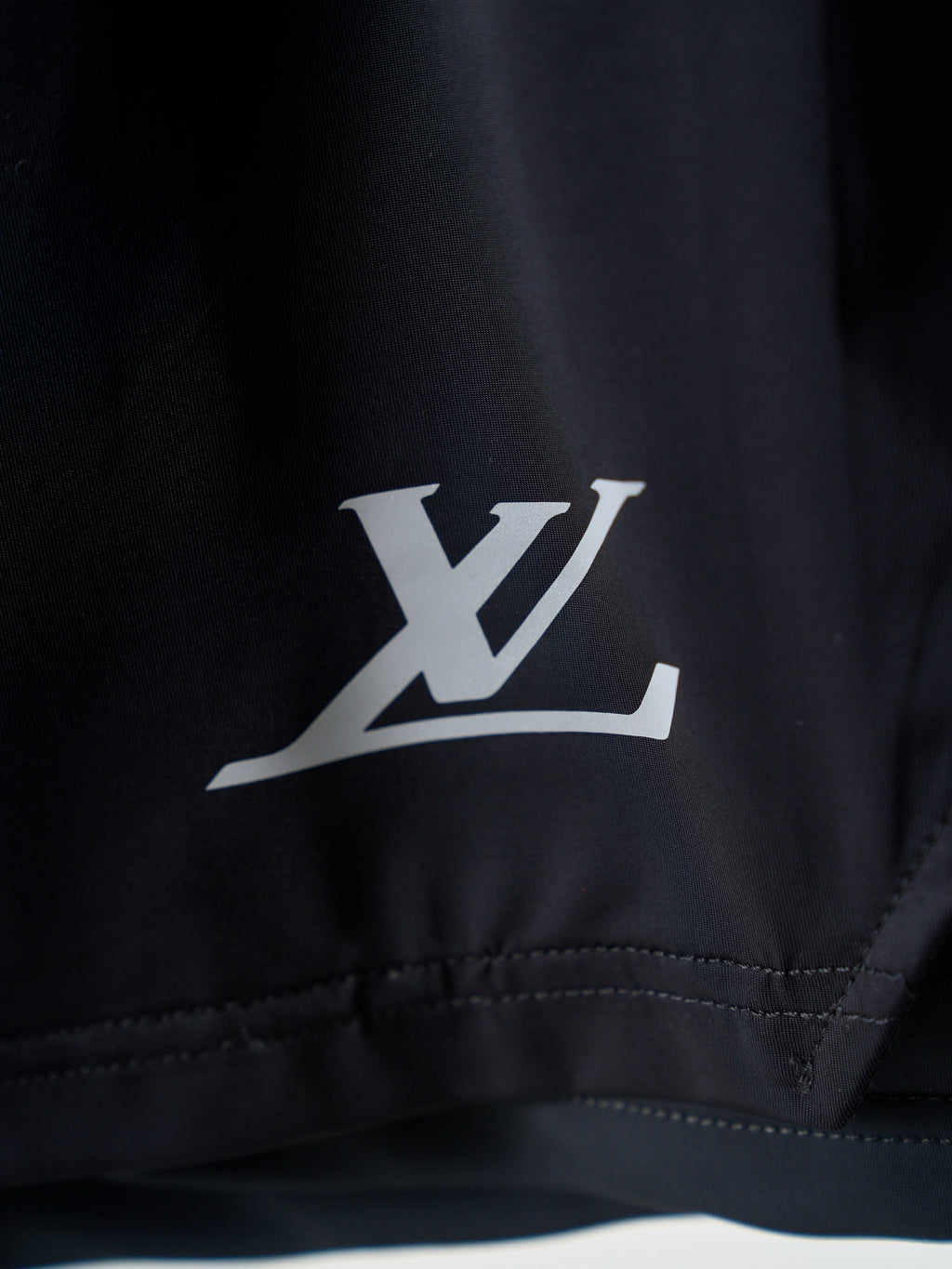 Louis Vuitton dark navy shorts with white LV logo on leg hem