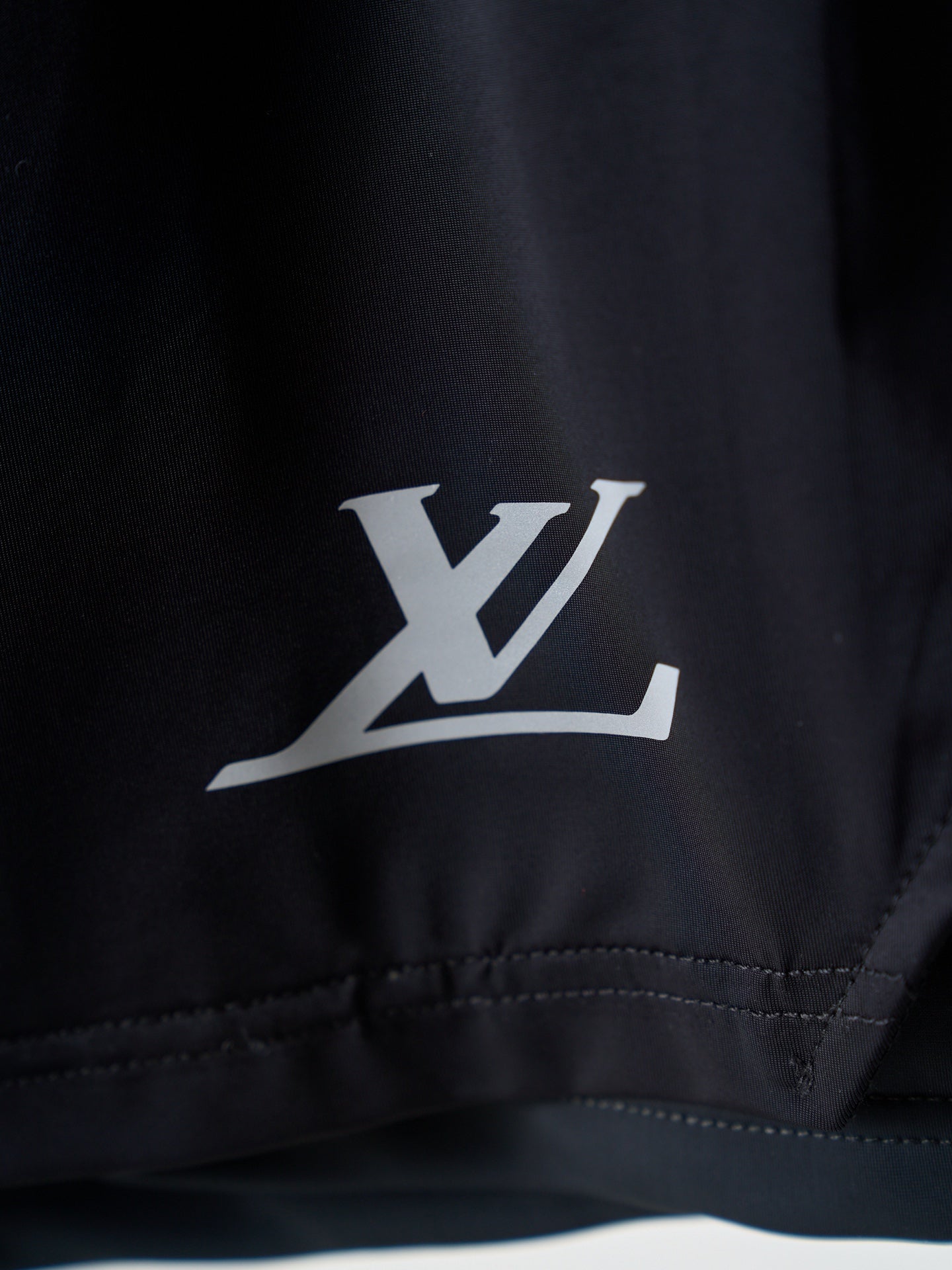 Louis Vuitton dark navy shorts with white LV logo on leg hem