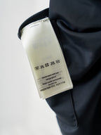 Louis Vuitton navy shorts care tag with washing symbols and product code