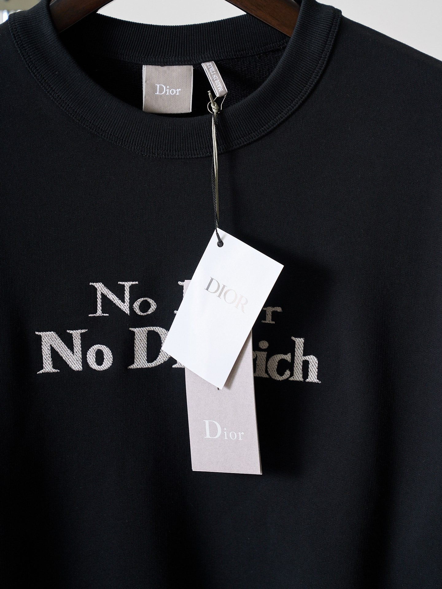 Black crewneck sweatshirt with 'No Dior No Dietrich' print and hanging tags