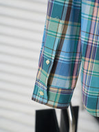 Plaid shirt sleeve cuff with button detail and logo tab