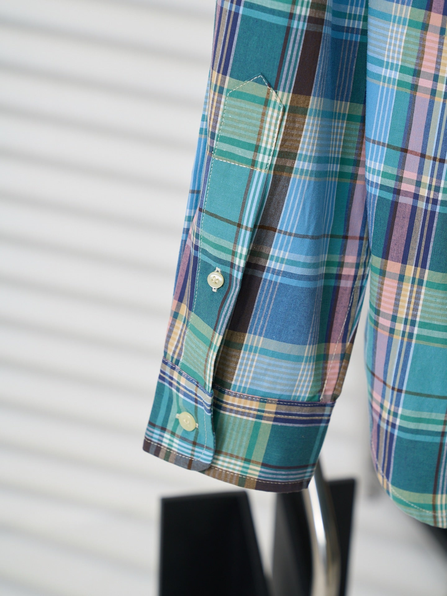 Plaid shirt sleeve cuff with button detail and logo tab