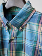 Turquoise plaid shirt collar and button placket detail with neck tape