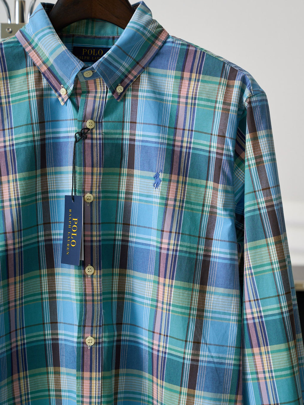 Turquoise plaid button-up shirt with embroidered logo on chest and button placket