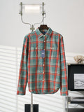 Teal plaid button-up shirt on hanger with pointed collar and white button placket