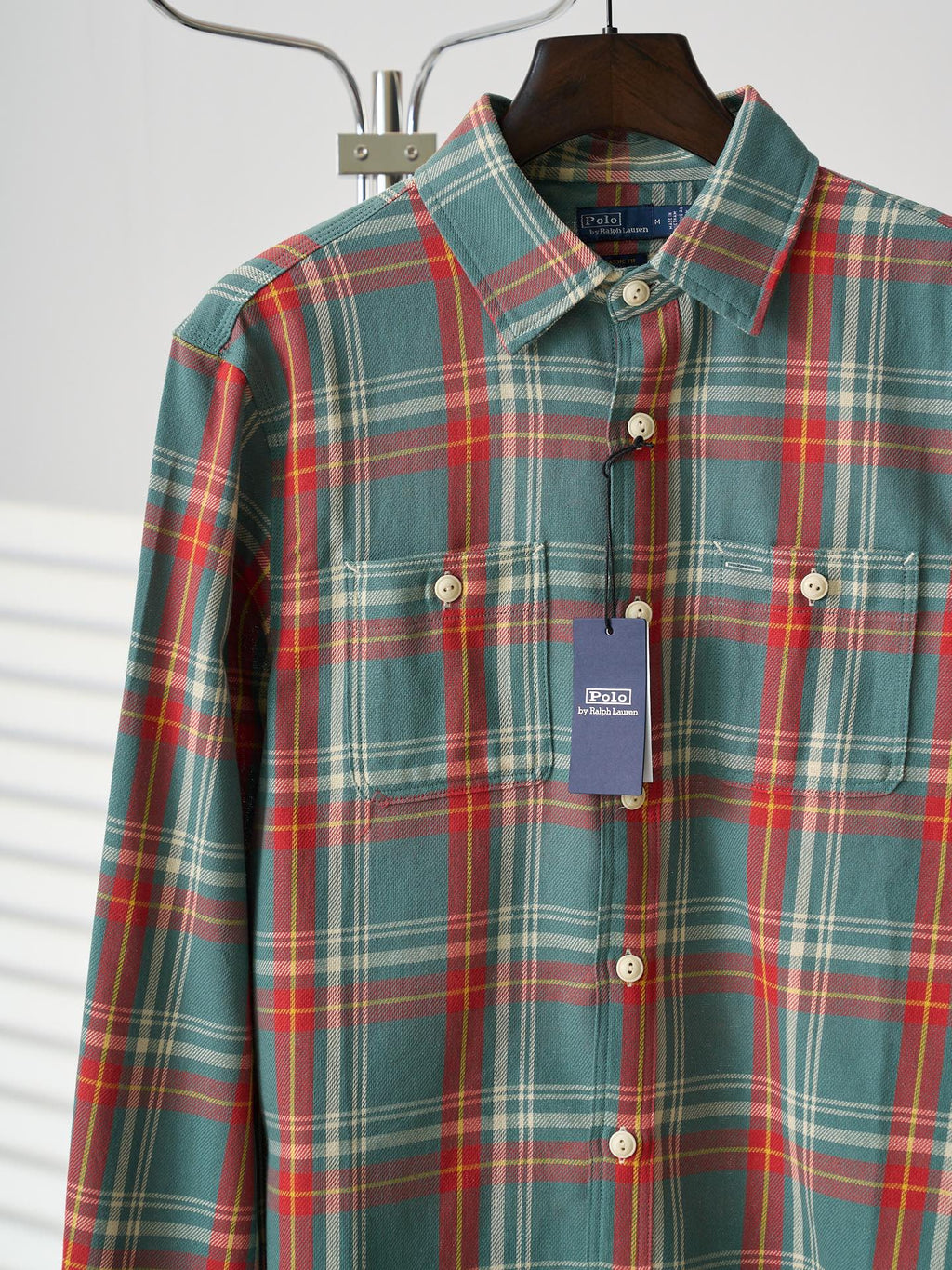 Teal plaid button-up shirt with long sleeves, white buttons, and a hanging brand tag