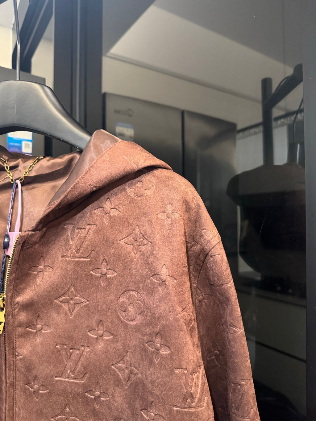 Louis Vuitton monogram hooded jacket, brown, close side view with zipper and pattern
