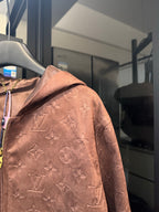 Louis Vuitton monogram hooded jacket, brown, close side view with zipper and pattern