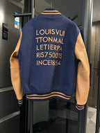 Long varsity jacket back in dark navy with gold text and striped rib collar