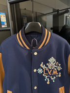 Long varsity jacket close-up with ribbed striped collar and multicolor LV crest on chest