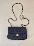 Chanel quilted denim shoulder bag with flap and gold CC logo, chain strap.
