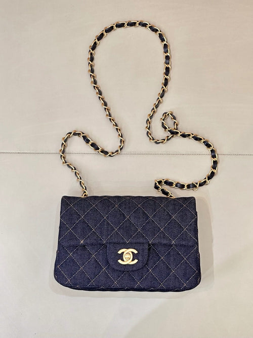 Chanel quilted denim shoulder bag with flap and gold CC logo, chain strap.