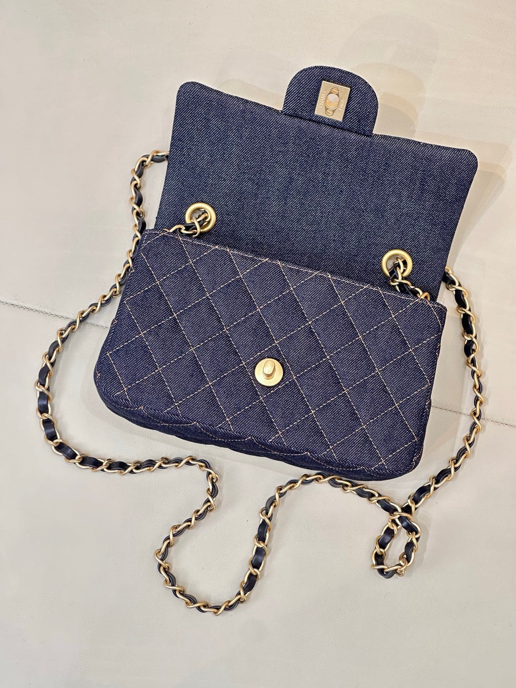 Chanel quilted denim bag with gold-tone hardware, chain shoulder strap.