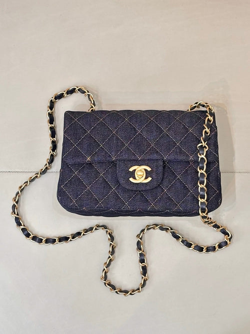 Chanel quilted denim flap shoulder bag with gold CC logo and chain strap.