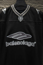 Balenciaga black polo shirt close-up of logo graphic and striped neckline