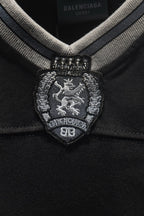 Balenciaga embroidered coat-of-arms crest at V-neck placket