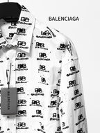 White long-sleeve shirt with pointed collar and Balenciaga monogram button details