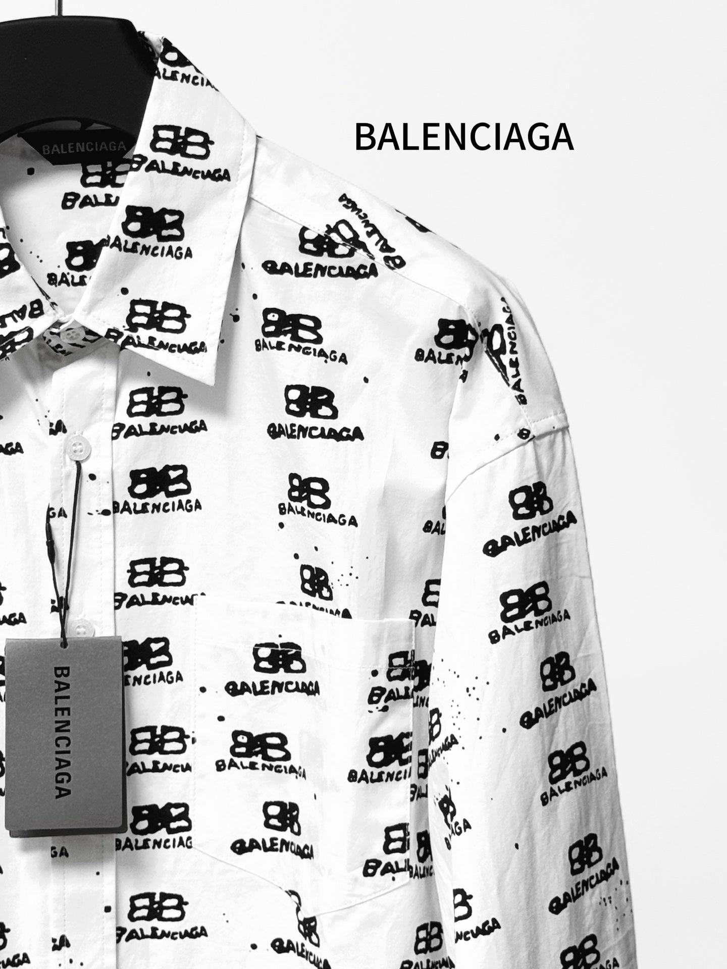 White long-sleeve shirt with pointed collar and Balenciaga monogram button details