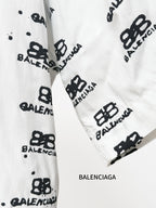 Balenciaga long-sleeve shirt cuff close-up in white with black repeating logo pattern
