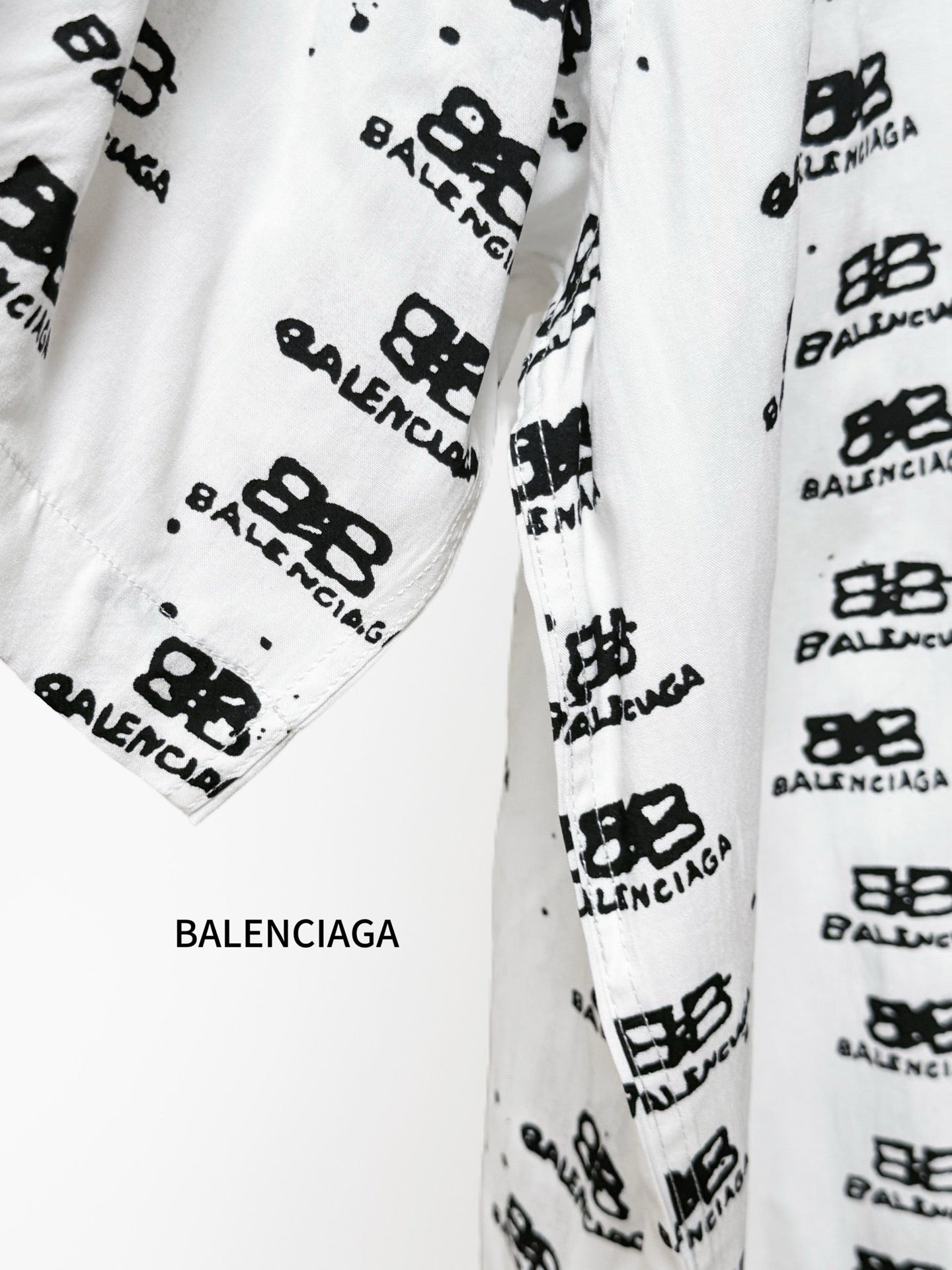 Balenciaga long-sleeve shirt sleeve close-up in white with black logo print