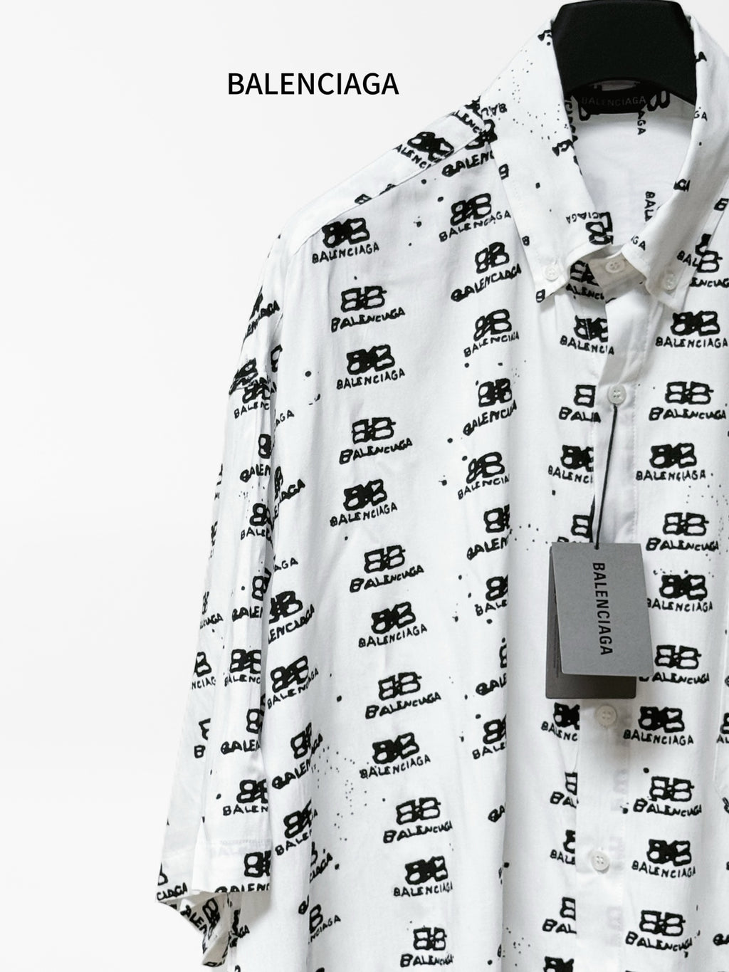Balenciaga long-sleeve shirt front three-quarter view in white with black logo print