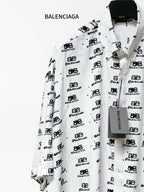 Balenciaga long-sleeve shirt front three-quarter view in white with black logo print