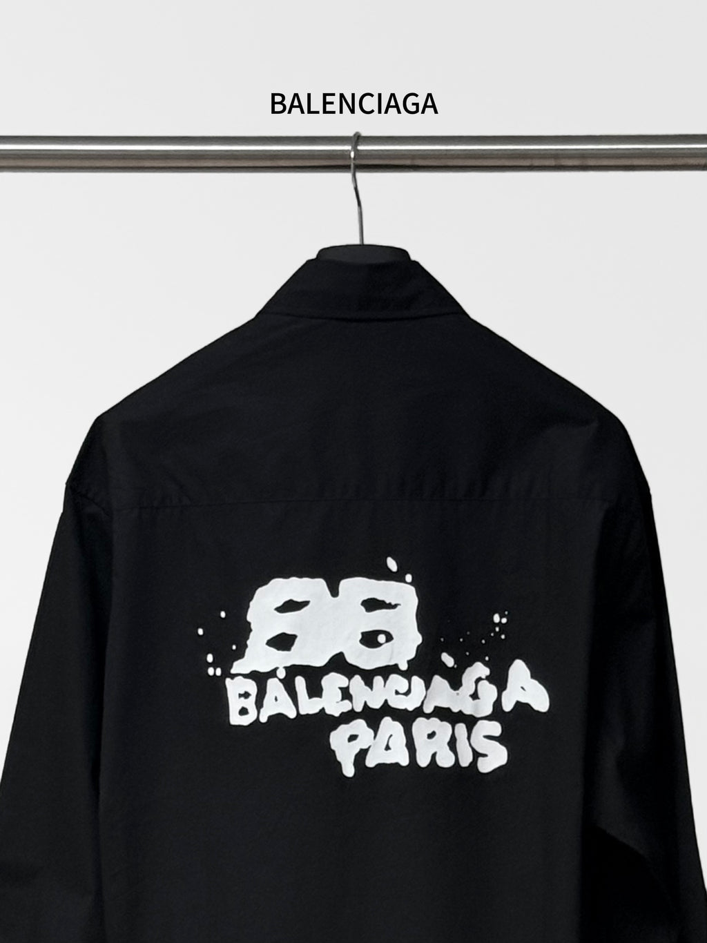 Balenciaga black long-sleeve button-up shirt back view with centered graphic print