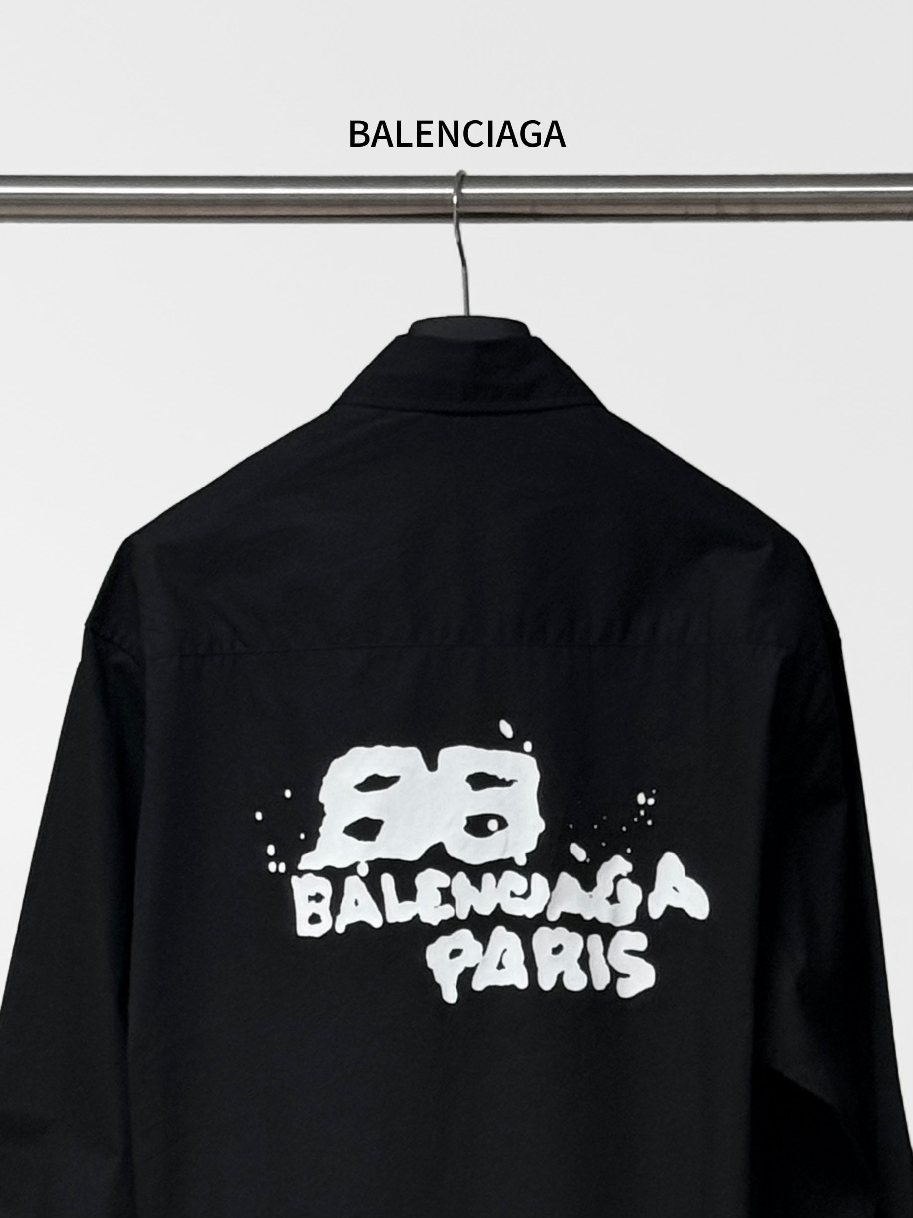 Balenciaga black long-sleeve button-up shirt back view with centered graphic print