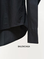 Black long-sleeve shirt with side seam detail and button cuff