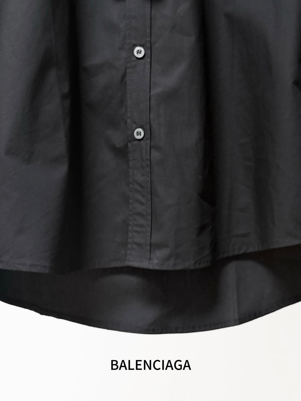 Black long-sleeve button front shirt with small round buttons