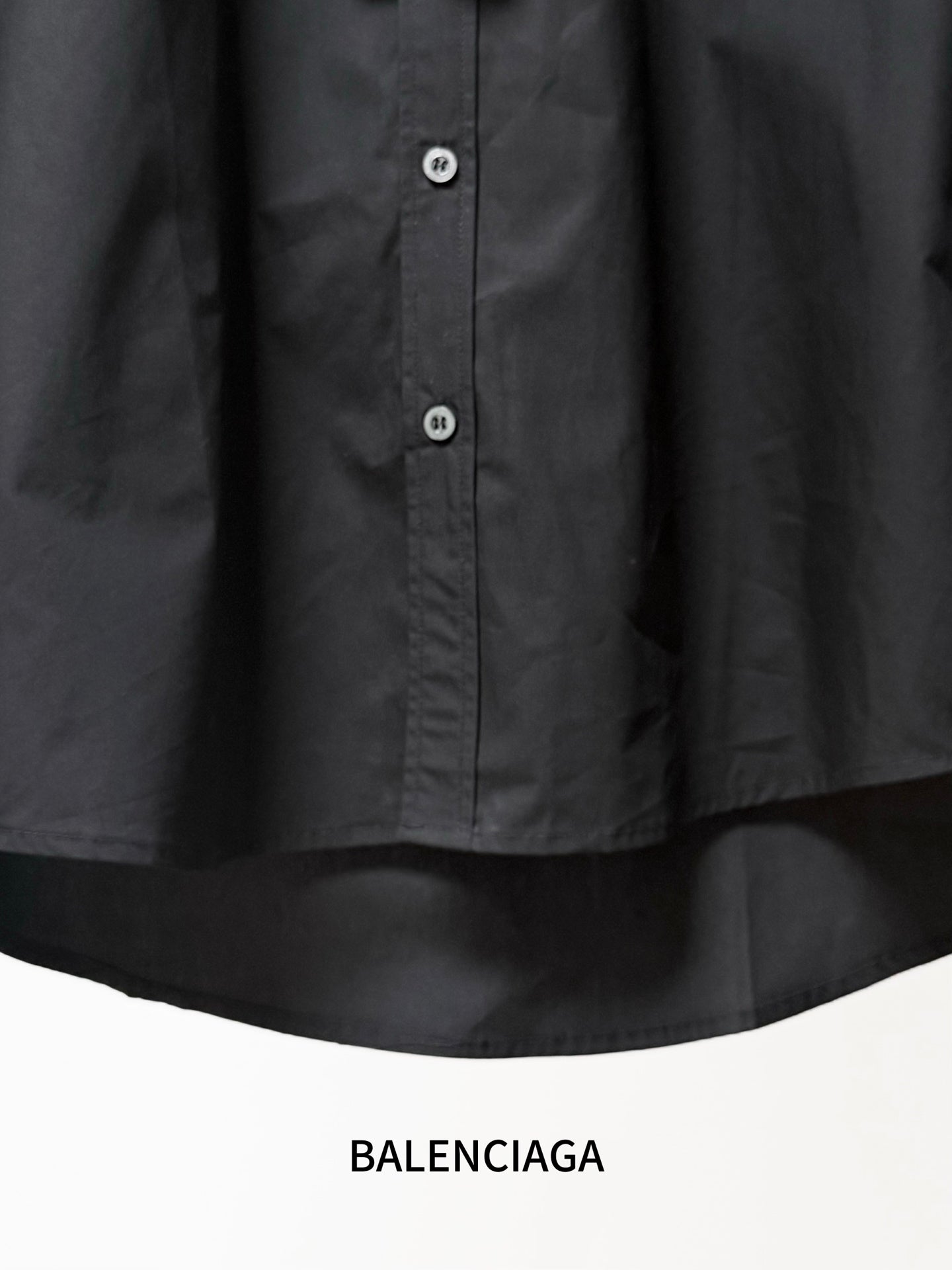 Balenciaga black long-sleeve button-up shirt close-up of button placket at front