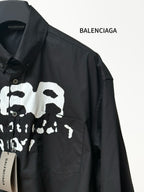 Black long-sleeve shirt with chest pocket and skull graphic print