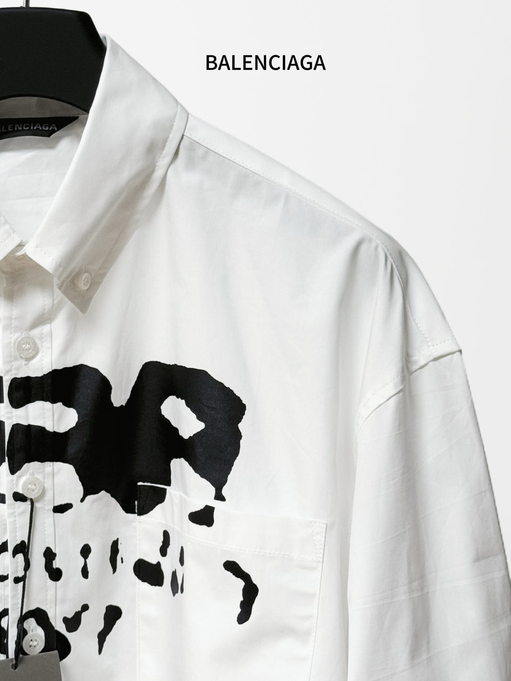 Balenciaga white button-up shirt with black logo graphic and button placket