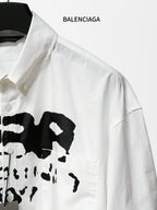 Balenciaga white button-up shirt with black logo graphic and button placket