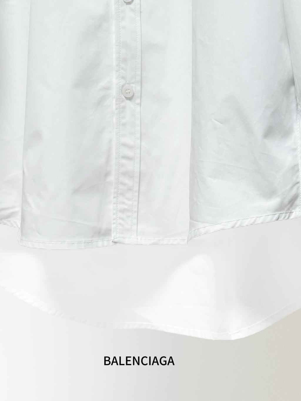 Balenciaga white button-up shirt with visible button placket and chest seam