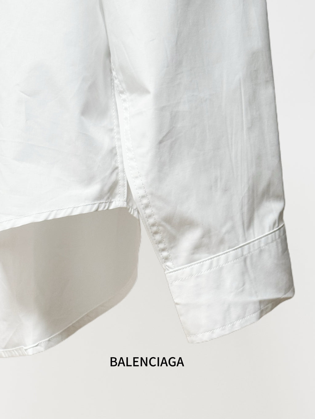 Balenciaga white long-sleeve shirt with curved hem and side seam stitching
