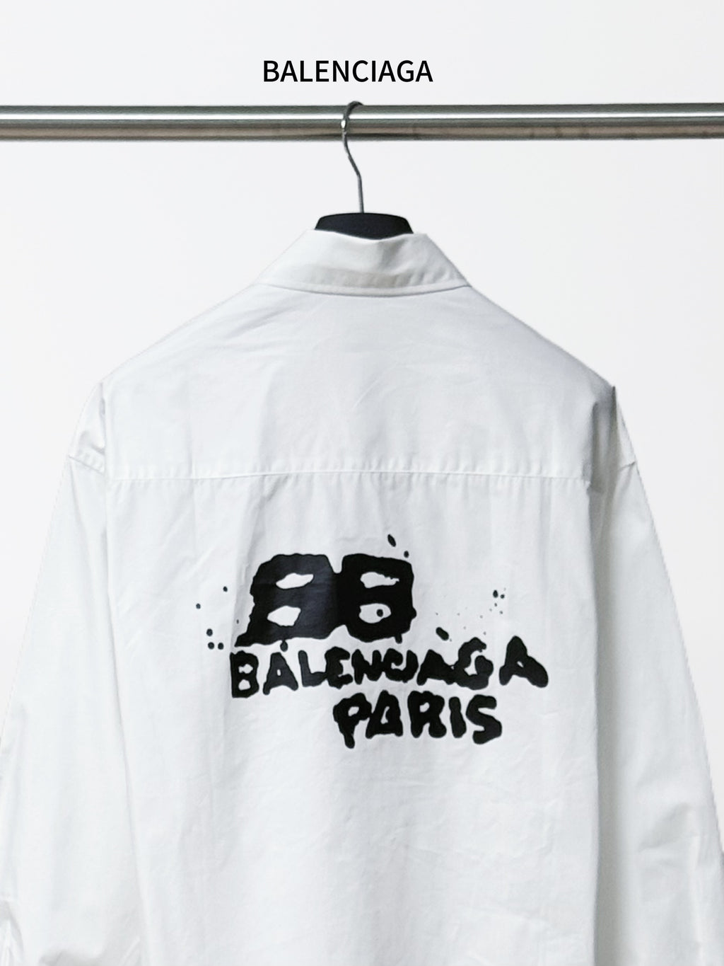 Balenciaga white button-up long-sleeve shirt with centered black 'BALENCIAGA PARIS' print