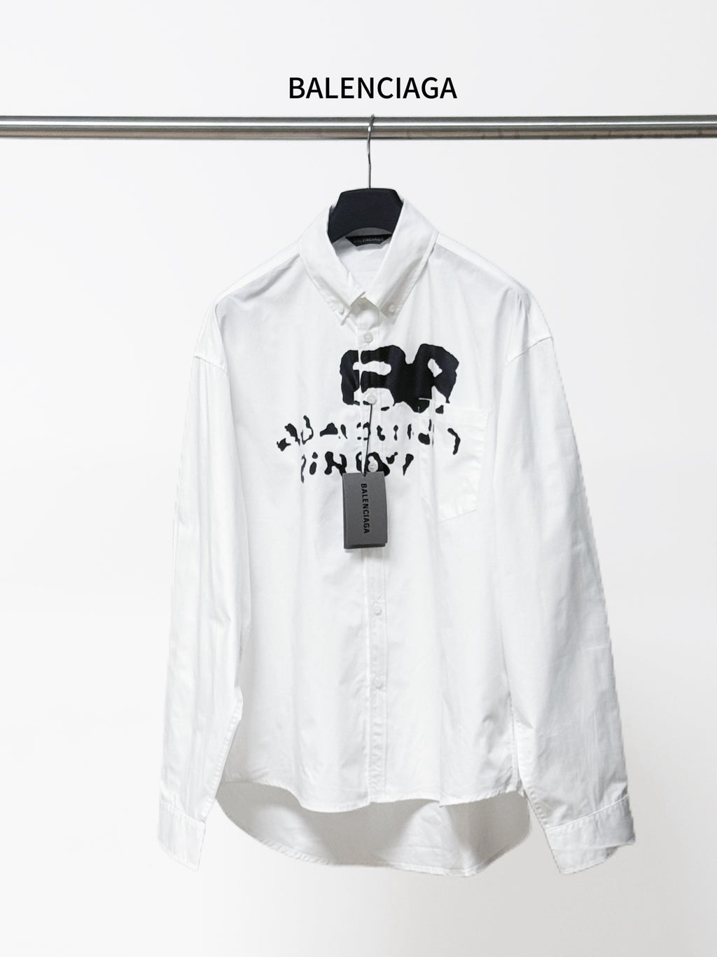 Balenciaga white button-up long-sleeve shirt with black graphic and neck tag
