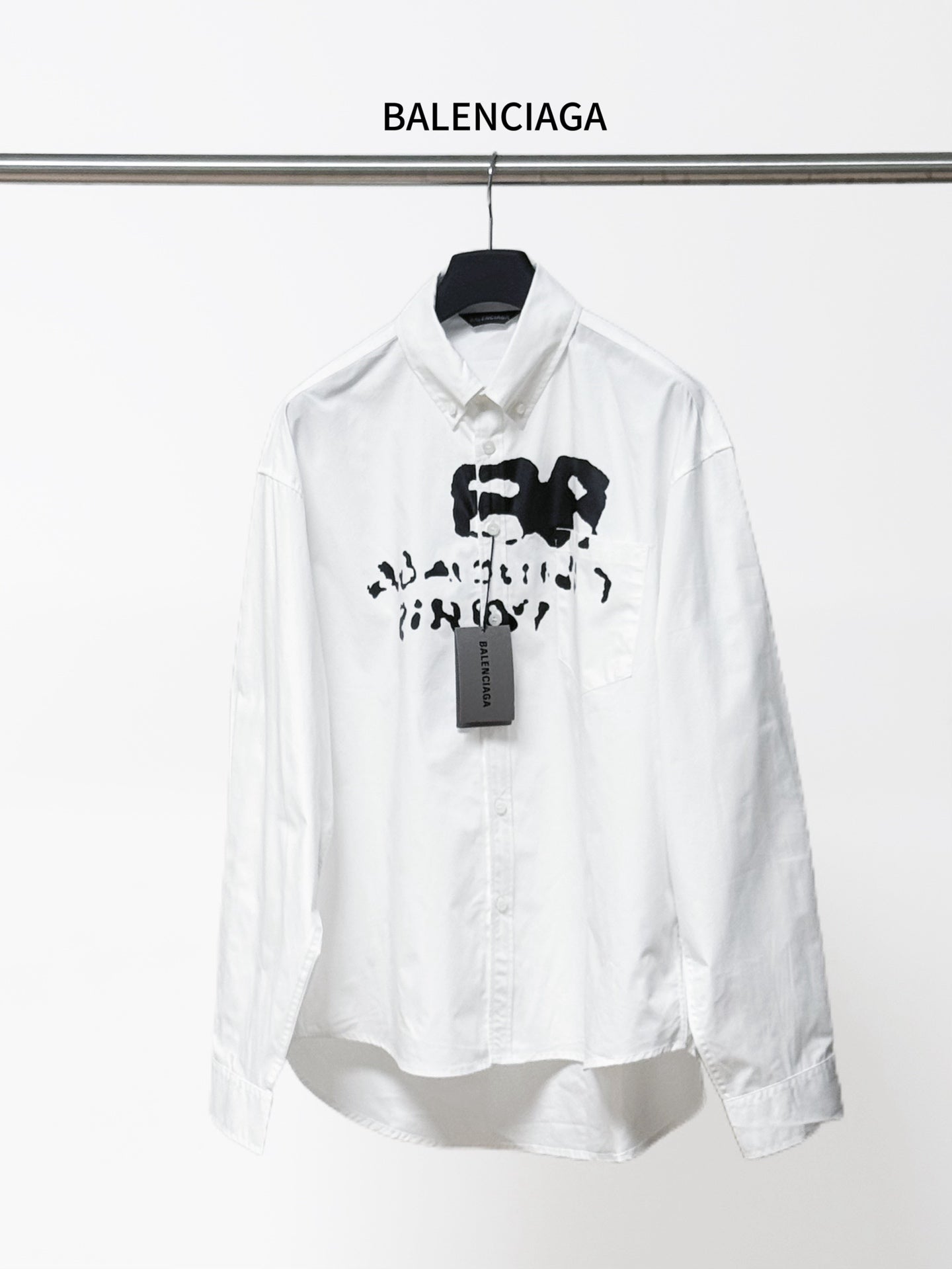 Balenciaga white button-up long-sleeve shirt with black graphic and neck tag