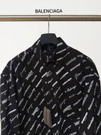 Black long-sleeve button-up shirt with repeating white script logo pattern, front close-up