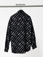 Black long-sleeve button-up shirt with repeating white script logo pattern, back view