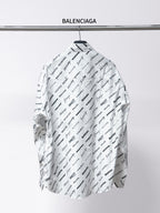 White long-sleeve shirt with spread collar, black Balenciaga script print on back