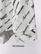 White logo-print shirt with curved hem and visible seam, angled view