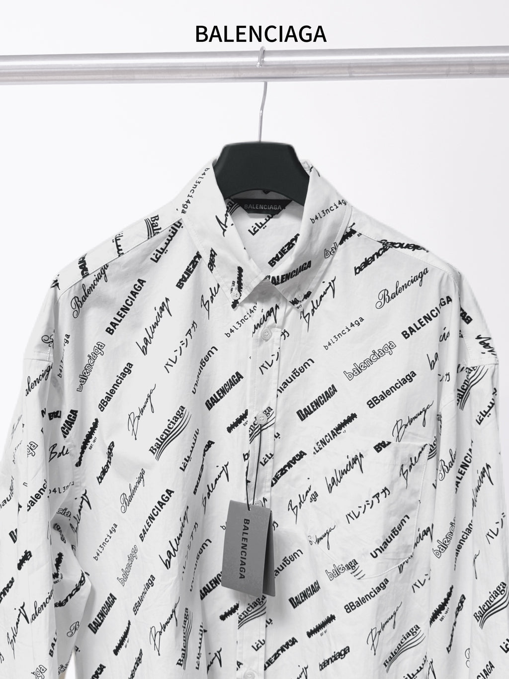 White long-sleeve button-up shirt with black Balenciaga script print and open collar