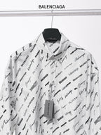 White long-sleeve button-up shirt with black Balenciaga script print and open collar