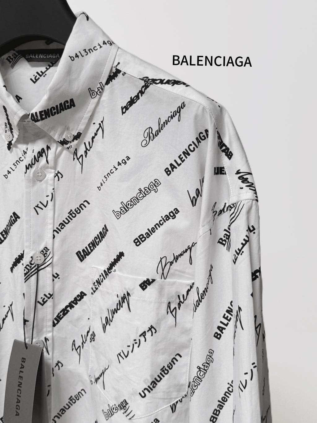 White long-sleeve shirt with scattered black Balenciaga logo and signature text