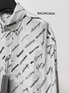 White long-sleeve shirt with scattered black Balenciaga logo and signature text