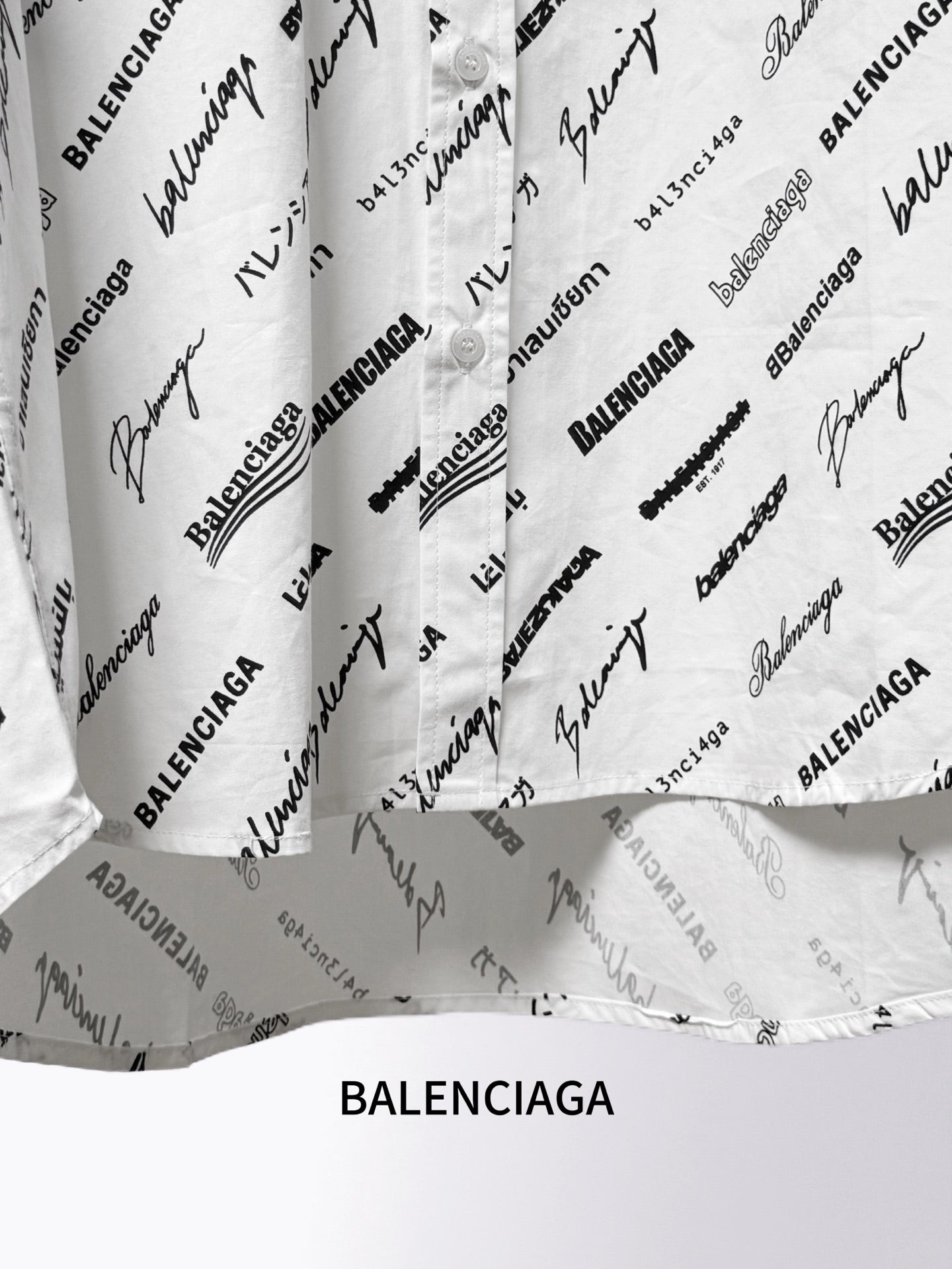 White shirt lower section with black Balenciaga script print and folded fabric