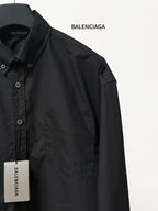Balenciaga long-sleeve button-up shirt, black, with chest pocket and side panel seams.