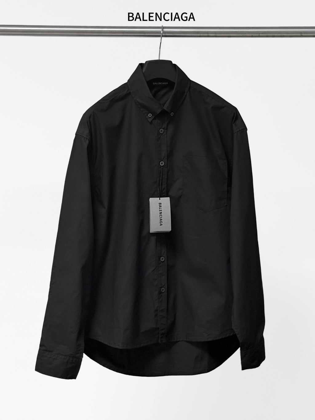 Long-sleeve button-up shirt by Balenciaga, dark black, front view with button placket.